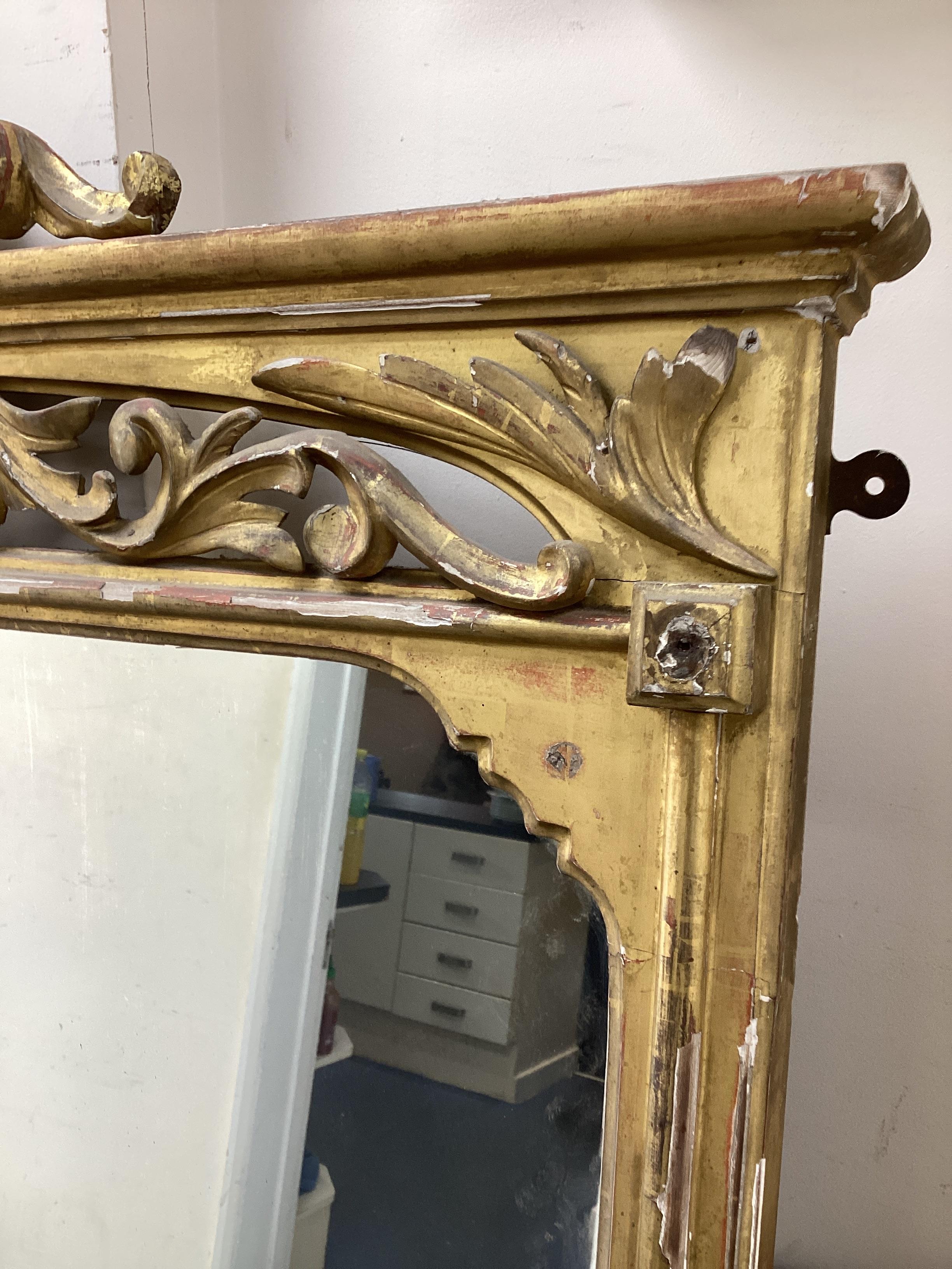 A Victorian carved giltwood overmantel mirror with ribbon fold pediment, width 156cm, height 186cm.